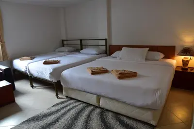 two beds sitting next to each other in a room at Baan Petcharat in Patong Beach