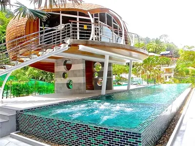 a house with a swimming pool with a spiral staircase at Emerald Patong New Studio with Balcony in Patong Beach