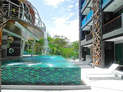 a swimming pool with a fountain in the middle of a building at Emerald Patong New Studio with Balcony in Patong Beach