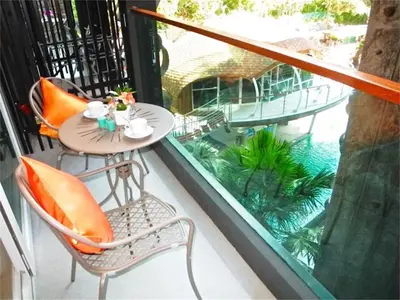 a balcony with a table and chairs on a balcony at Emerald Patong New Studio with Balcony in Patong Beach