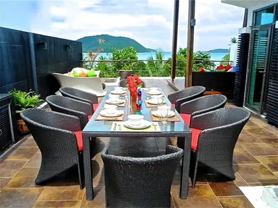 a dining table and chairs on a patio at Eva Villa Rawai 3 bedrooms Private Pool in Rawai Beach