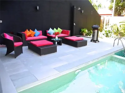 a patio with couches and chairs next to a pool at Eva Villa Rawai 3 bedrooms Private Pool in Rawai Beach