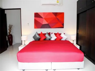 a bedroom with a large red bed with red pillows at Intira Villa Rawai 2 bedrooms Villa in Rawai Beach