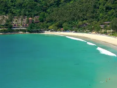 an aerial view of a beach with people in the water at Intira Villa Rawai 2 bedrooms Villa in Rawai Beach