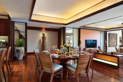 a dining room with a table and chairs at Andara Resort Villas in Kamala Beach