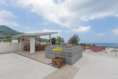 a patio with a gazebo on the roof of a house at The Palms, Kamala Beach - SHA Extra Plus in Kamala Beach