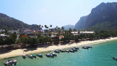 a group of boats in the water on a beach at Vacation Village Phra Nang Inn - SHA Extra Plus in Ao Nang Beach