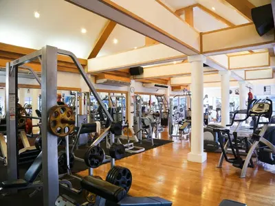 a gym with lots of treadmills and weights at The Yorkshire Hotel - SHA Certified in Patong Beach
