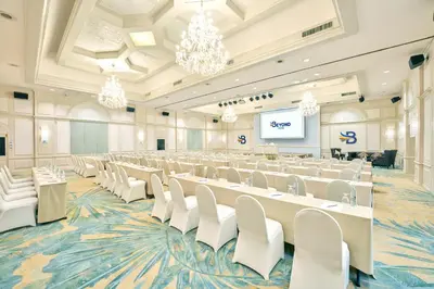 a large banquet hall with white tables and chairs at Beyond Kata in Kata Beach