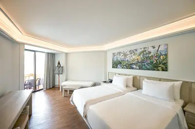 a hotel room with two beds and a desk at Beyond Kata in Kata Beach