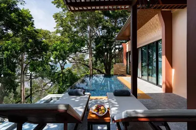 an outdoor patio with a swimming pool and a house at Avani Ao Nang Cliff Krabi Resort in Ao Nang Beach