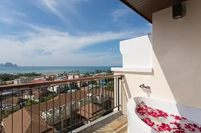 a balcony with a view of the ocean at Avani Ao Nang Cliff Krabi Resort in Ao Nang Beach