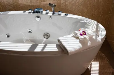 a white bath tub with a towel and a sink at Avani Ao Nang Cliff Krabi Resort in Ao Nang Beach