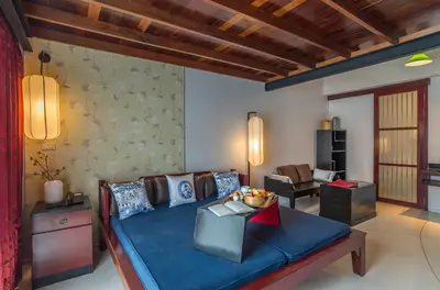 a living room with a couch and a table at Red Ginger Chic Resort in Ao Nang Beach