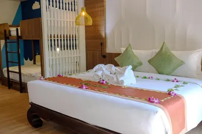 a large white bed with flowers on top of it at Nipa Resort, Patong Beach in Patong Beach