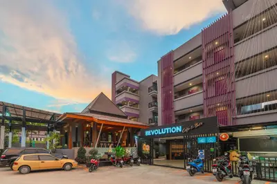 a building with cars parked in front of it at Phuvaree Resort in Patong Beach