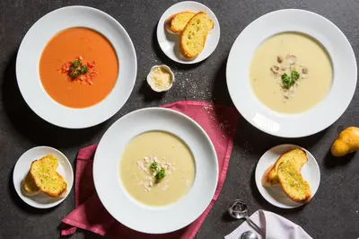 a group of four bowls of soup with bread at Phuvaree Resort in Patong Beach
