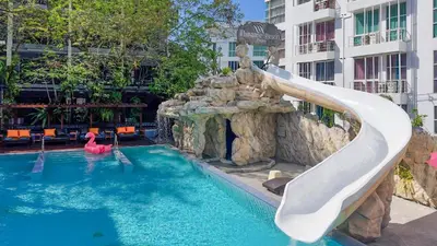 a slide in a swimming pool in a hotel at Phuvaree Resort in Patong Beach