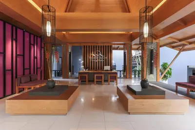 a lobby with wooden furniture and a large organ at Phuvaree Resort in Patong Beach