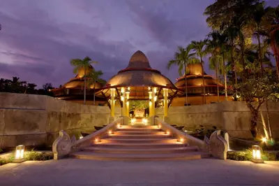 a building with stairs and lights in front at The Village Resort - SHA Plus in Karon Beach