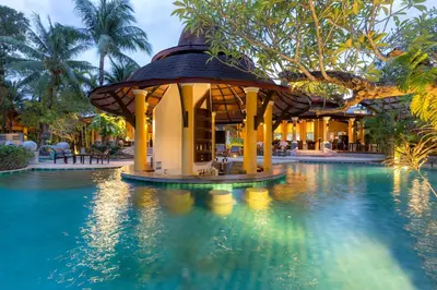 a resort swimming pool with a gazebo in the water at The Village Resort - SHA Plus in Karon Beach