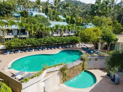 an overhead view of a swimming pool with chairs and trees at Krabi Tipa Resort in Ao Nang Beach