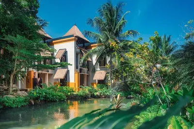 a house with a river in front of it at Paradox Resort Phuket in Karon Beach