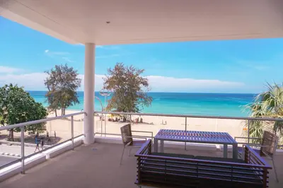 a balcony with a bench and a view of the beach at Paradox Resort Phuket in Karon Beach