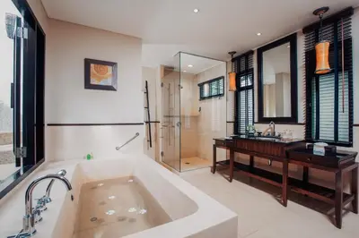 a large bathroom with a tub and a sink at Paradox Resort Phuket in Karon Beach