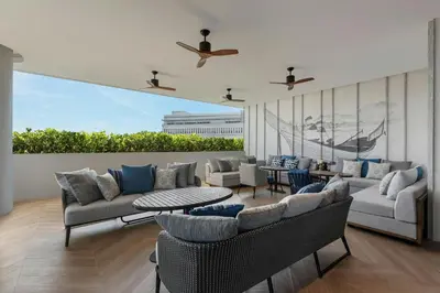 a living room with couches and chairs and a table at Courtyard by Marriott Phuket Town in Phuket Town
