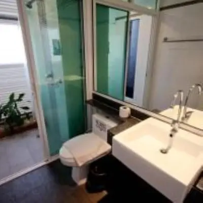 a bathroom with a sink and a toilet and a mirror at Kata Beach Studio Phuket in Kata Beach