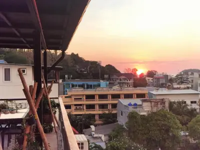 a view of the sunset from the roof of a building at Kata Beach Studio Phuket in Kata Beach
