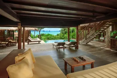 a living room with a couch and a table at Six Senses Yao Noi in Ko Yao Noi
