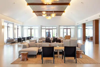 a large lobby with couches and tables and windows at Sunwing Kamala Beach in Kamala Beach