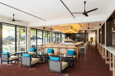 a restaurant with tables and chairs and a bar at Nap Patong in Patong Beach