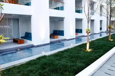 an external view of a building with a swimming pool at Nap Patong in Patong Beach