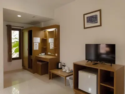 a living room with a television and a bathroom at Sunda Resort in Ao Nang Beach