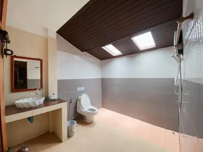 a bathroom with a toilet and a sink and a shower at Sunda Resort in Ao Nang Beach