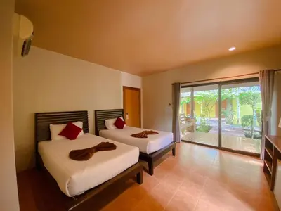a bedroom with two beds and a balcony at Sunda Resort in Ao Nang Beach