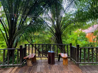two benches sitting on a deck with a fence at Sunda Resort in Ao Nang Beach