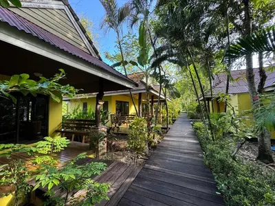 a wooden walkway in front of a house at Sunda Resort in Ao Nang Beach