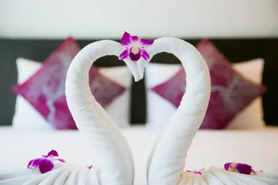 two white swans making a heart on a bed at Apasari Krabi - SHA Extra Plus in Ao Nang Beach