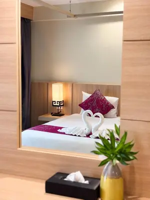 a bedroom with a bed with two swans on it at Apasari Krabi - SHA Extra Plus in Ao Nang Beach