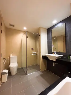 a bathroom with a toilet and a sink and a shower at Apasari Krabi - SHA Extra Plus in Ao Nang Beach