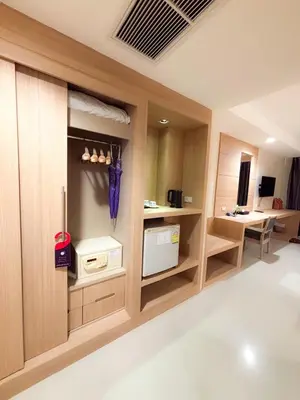a room with a kitchen with a door and a room with aperature at Apasari Krabi - SHA Extra Plus in Ao Nang Beach