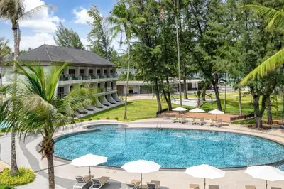 an image of a swimming pool at a resort with umbrellas at Amora Beach Resort Phuket in Bang Tao Beach