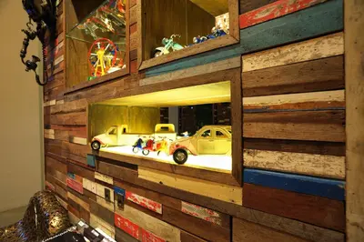 a brick wall with a reflection of cars in a mirror at The Album Hotel in Patong Beach