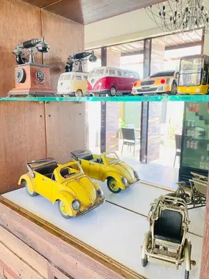 a group of toy cars sitting on a shelf at The Album Hotel in Patong Beach