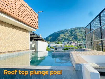 a pool with a roof top plunge pool on a building at The Album Hotel in Patong Beach