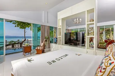 a bedroom with a bed and a view of the ocean at Racha Island Resort (Rayaburi) in Ko Racha Yai